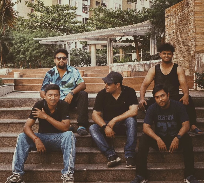 Between Blanks band sitting together on stairs